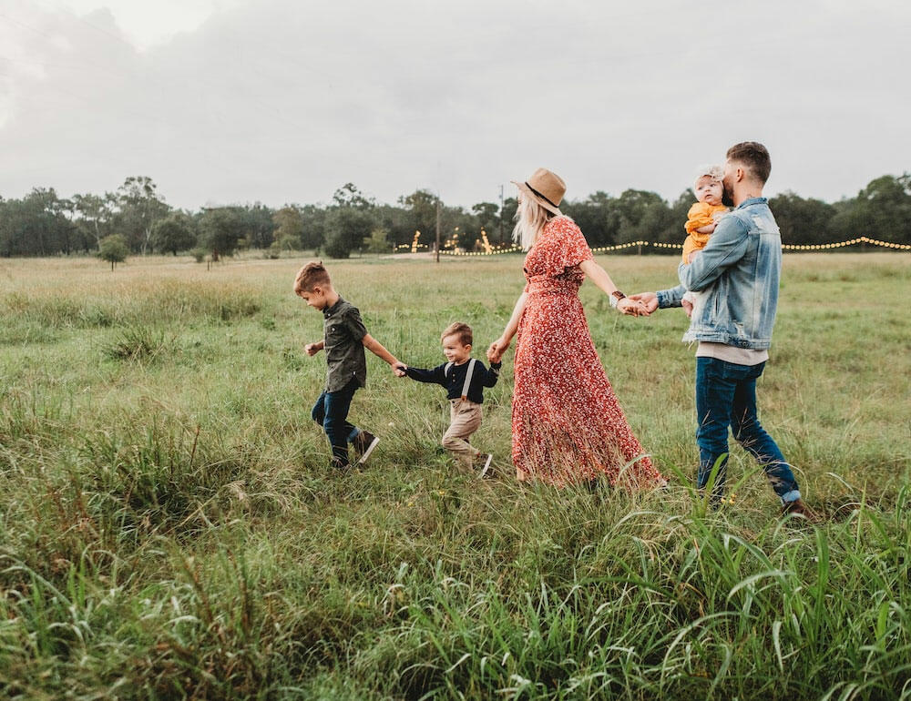 7 Tips and Tricks on How to Shoot Family Portraits 4 woman holding man and toddler hands during daytime